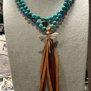 Turquoise color beaded necklace with leather tassel and silver plated dragonfly!